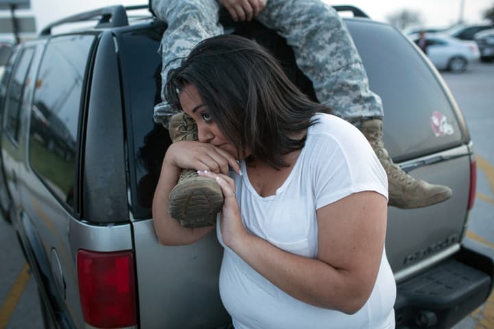 Lucy Hamlin and her husband, Spc. Timothy Hamlin wait for permission to re-enter the Fort Hood military base, where they live, following a shooting on base on Wednesday, April 2, 2014, in Fort Hood, Texas. (AP)