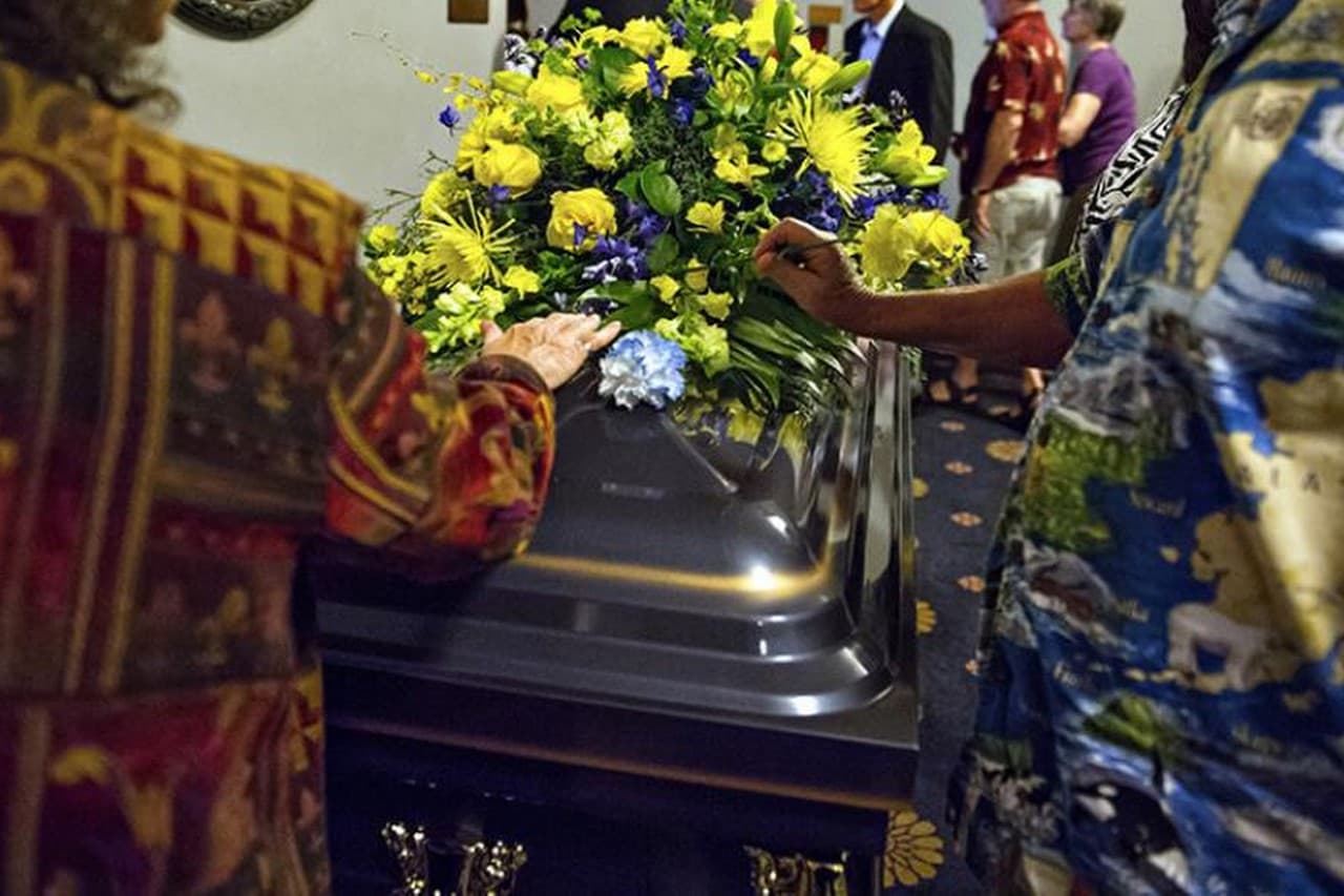 In this September of 2013 photo released by the University of Michigan Health System, families lay flowers on a casket containing donors’ cremated remains at the University of Michigan Medical School’s annual memorial service in Ann Arbor, Mich. (AP)