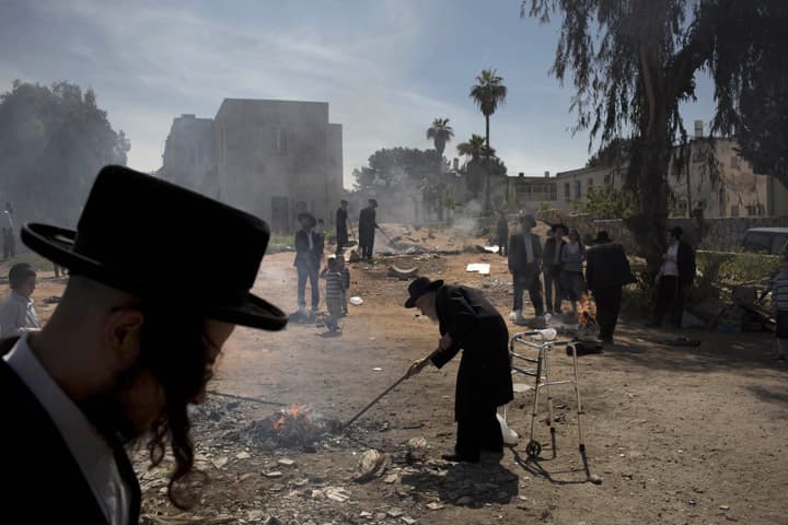 Ultra-Orthodox Jewish men burn leavened items in final preparation for the Passover holiday in the ultra-Orthodox Jewish town of Bnei Brak, near Tel Aviv, Israel, Monday, April 14, 2014. Jews are forbidden to eat leavened foodstuffs during the Passover holiday that celebrates the biblical story of the Israelites' escape from slavery and exodus from Egypt. (AP)