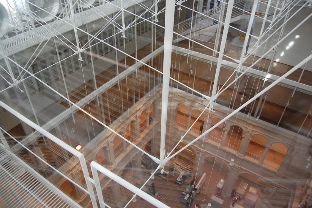 Looking down from the glass-roofed atrium of the renovated Harvard Art Museums to the courtyard floor five stories below. (Greg Cook)