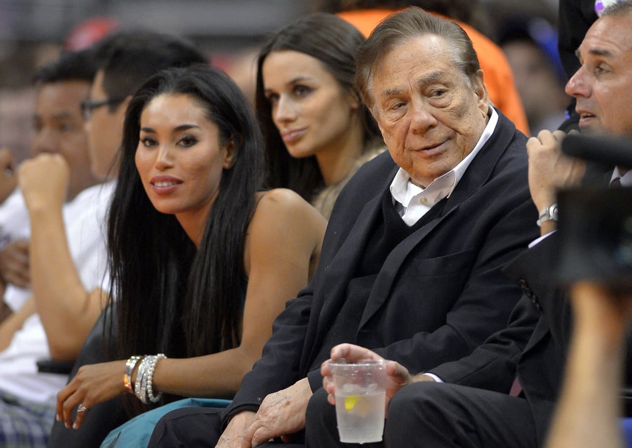 An October 2013 photo shows Los Angeles Clippers owner Donald Sterling, right, and V. Stiviano, left. (AP)