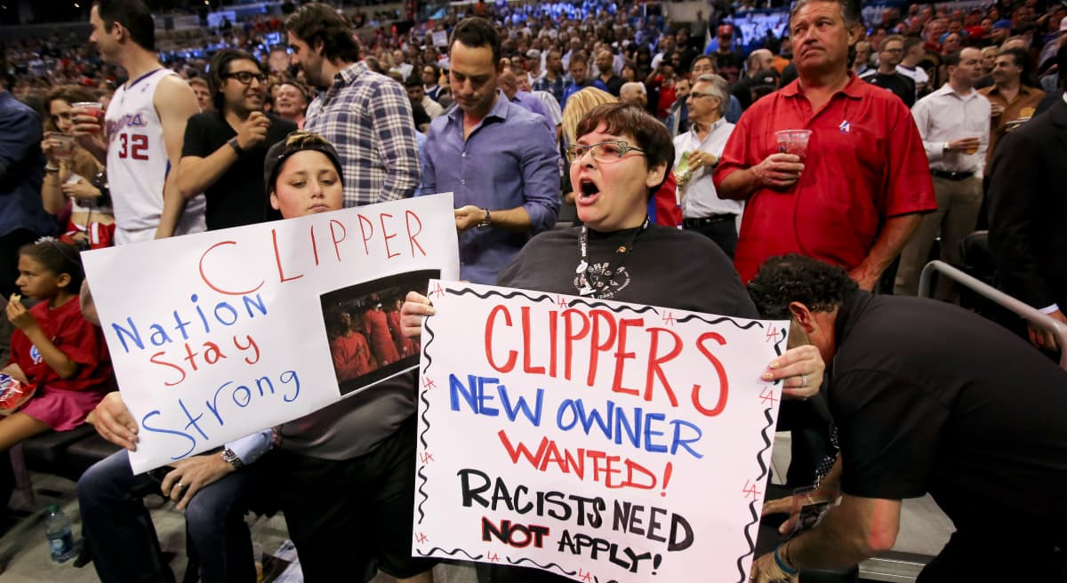 In this photo, fans hold up signs in support of the Los Angeles Clippers before Game 5 of an opening-round NBA basketball playoff series between the Clippers and the Golden State Warriors on Tuesday, April 29, 2014, in Los Angeles. NBA Commissioner Adam Silver announced Tuesday that Clippers owner Donald Sterling has been banned for life by the league. (Ringo H.W. Chiu/AP)