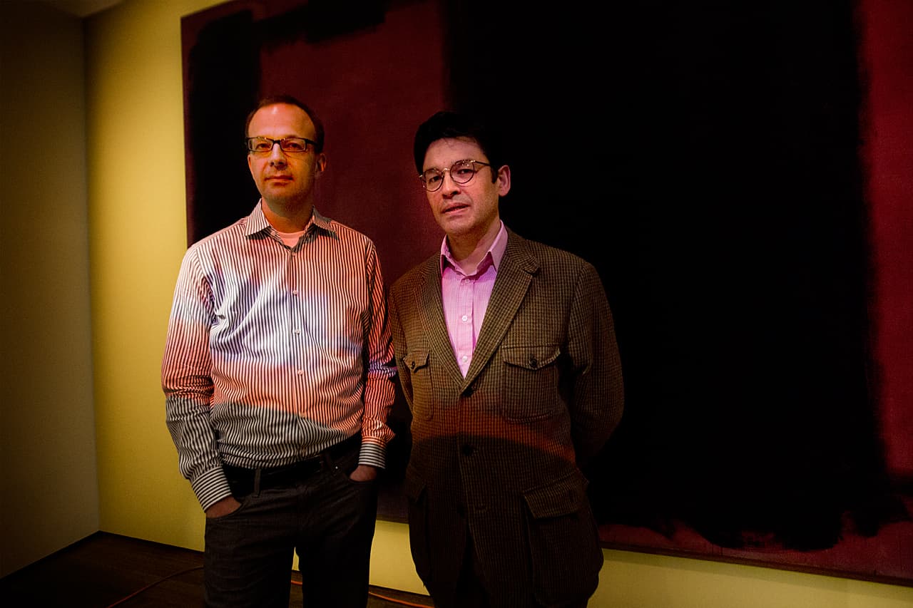 In this WBUR file photo, Narayan Khandekar, right, senior conservation scientist at the Straus Center for Conservation and Technical Studies at the Harvard Art Museums, and conservation scientist  Jens Stenger stand in front of one of the restored Rothko paintings. (Jesse Costa/WBUR)