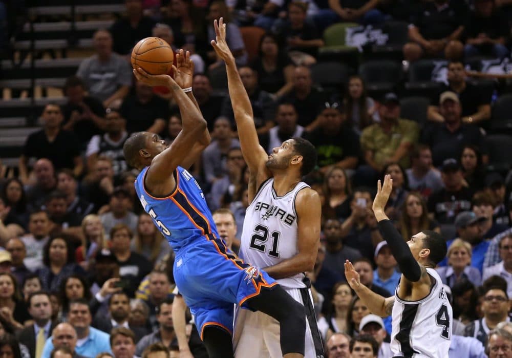 Oklahoma City's Kevin Durant (left) gets off a shot with San Antonios Tim Duncan in his face. A team of researchers say that by accounting for shot difficulty, they  were able to prove that the &quot;hot hand&quot; exists. (Ronald Martinez/Getty Images)