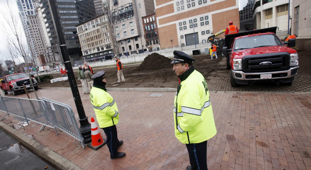 Work crews bring in new top soil behind a police barricade at the site of the Occupy Boston encampment in Dewey Square in Boston, Saturday, Dec. 10, 2011. More than 40 people were peacefully arrested as the park was cleared by police. (Michael Dwyer/AP)