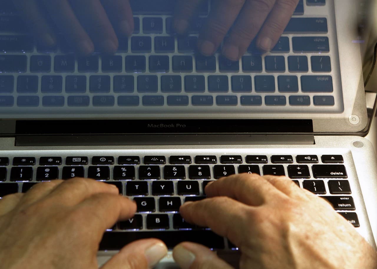 In this Wednesday, Feb. 27, 2013 photo illustration, hands type on a computer keyboard in Los Angeles. In the wake of the Heartbleed security threat, many security experts recommend a second layer of authentication _ typically in the form of a numeric code sent as a text message. You enter that code on the website to verify that it’s really you and not a hacker who doesn’t have your phone. (AP)