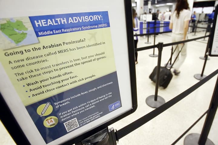 A Center for Disease Control health advisory warning travelers about the risks of MERS, or Middle East Respiratory Syndrome, is shown at a TSA screening area, Wednesday, May 14, 2014 at Miami International Airport in Miami. MERS is a respiratory illness that begins with flu-like fever and cough but can lead to shortness of breath, pneumonia and death. (AP)