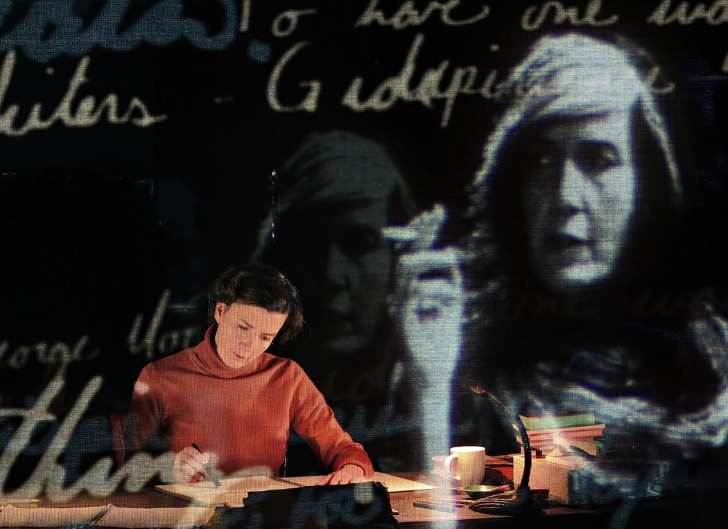 A projection of Susan Sontag looks on at her younger self, both played by Moe Angelos in "Sontag: Reborn" at the Paramount Center. (James Riggs)