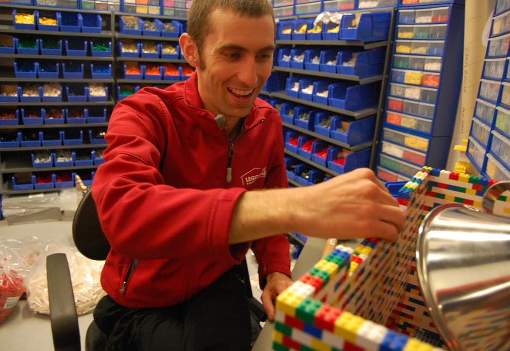 I’ve got the coolest job in the world,” says Ian Coffey, master model builder at Legoland, pictured here in his workshop stocked with tens of thousands of Lego bricks. (Greg Cook)
