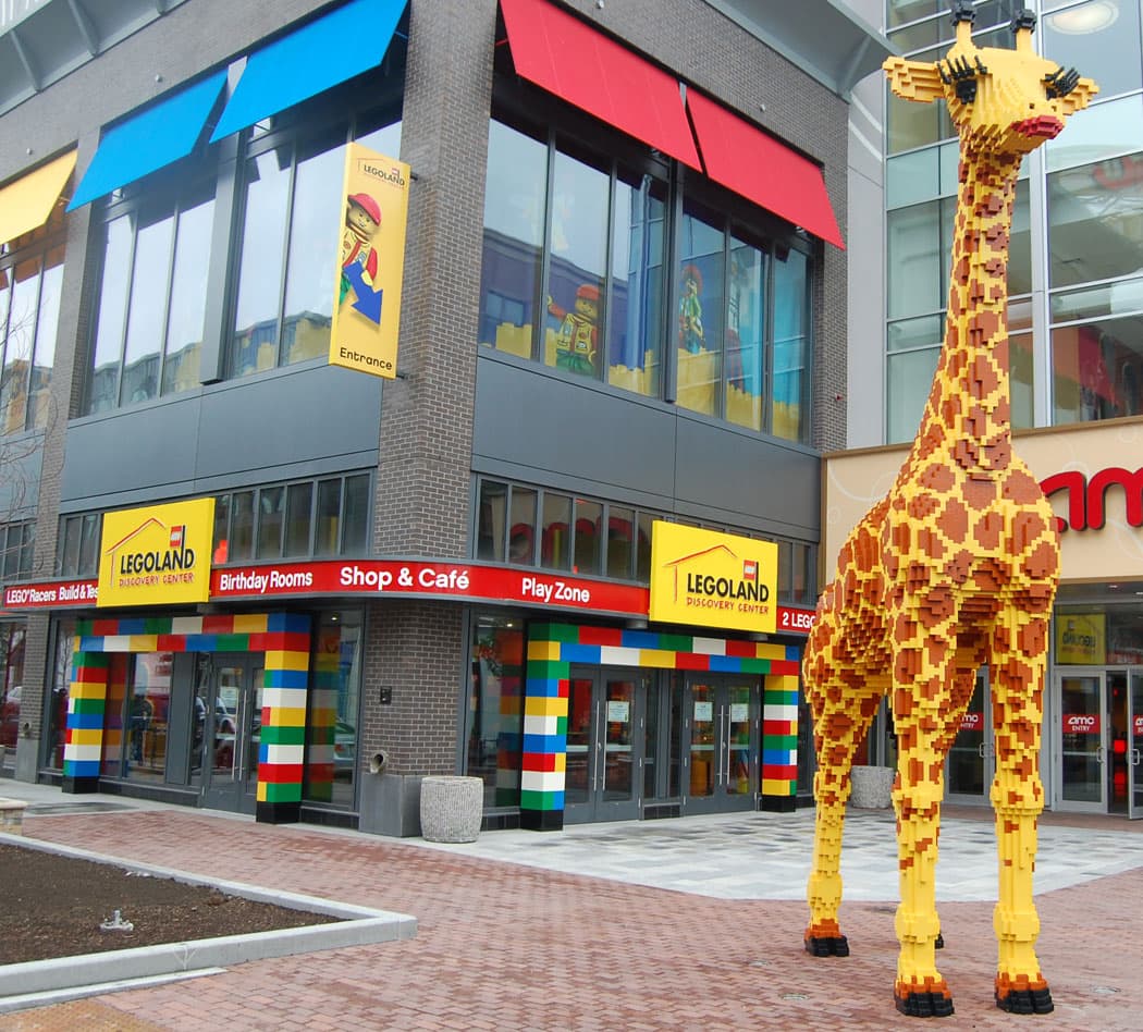 A giant Lego giraffe serves as a landmark outside Legoland’s entrance at Somerville’s Assembly Row mall. (Greg Cook)