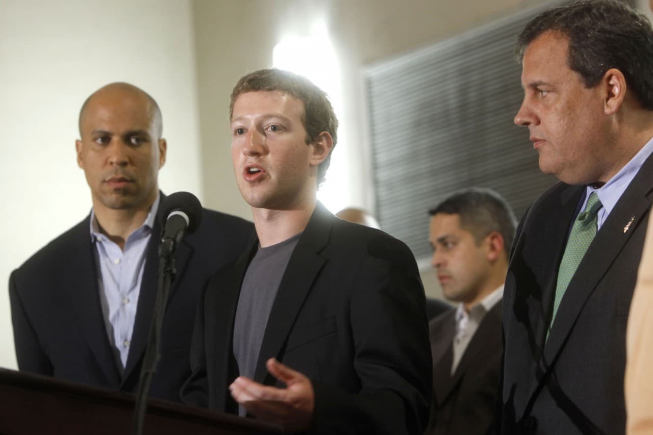 In this file photo released by Facebook, Facebook Chief Executive Officer Mark Zuckerberg, center, is joined by Cory A. Booker, left, the Mayor of Newark, N.J., and N.J. Governor Chris Christie, Saturday, Sept. 25, 2010 in Newark, N.J. at a news conference detailing a $100 million deal with New Jersey schools that Zuckerberg and Booker announced earlier in the week. (AP)