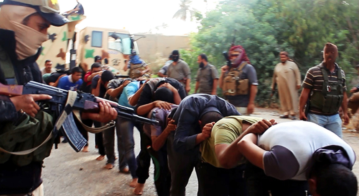 John Tirman: The swiftness of ISIS’s advances in Iraq has startled many observers. What Americans have failed to appreciate, however, is how devastated Iraq was by the U.S. war and how that is affecting Iraq now. This image posted on a militant website on Saturday, June 14, 2014, which has been verified and is consistent with other AP reporting, appears to show militants from the al-Qaida-inspired Islamic State of Iraq and the Levant (ISIL) leading away captured Iraqi soldiers dressed in plain clothes after taking over a base in Tikrit, Iraq. (AP Photo via militant website)