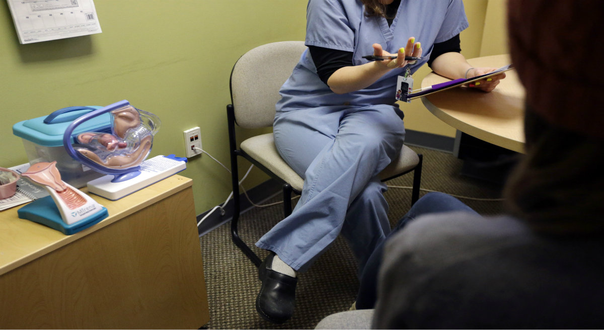 Jacqui Morton: I wish we could support each other rather than fight over lines on the sidewalk. Pictured: A medical clinician interviews a patient at a Planned Parenthood location in Boston. On Thursday, June 26, 2014, the Supreme Court unanimously struck down a Massachusetts law that prohibits abortion protests any closer than 35 feet from the entrance to clinics.(Steven Senne/AP)