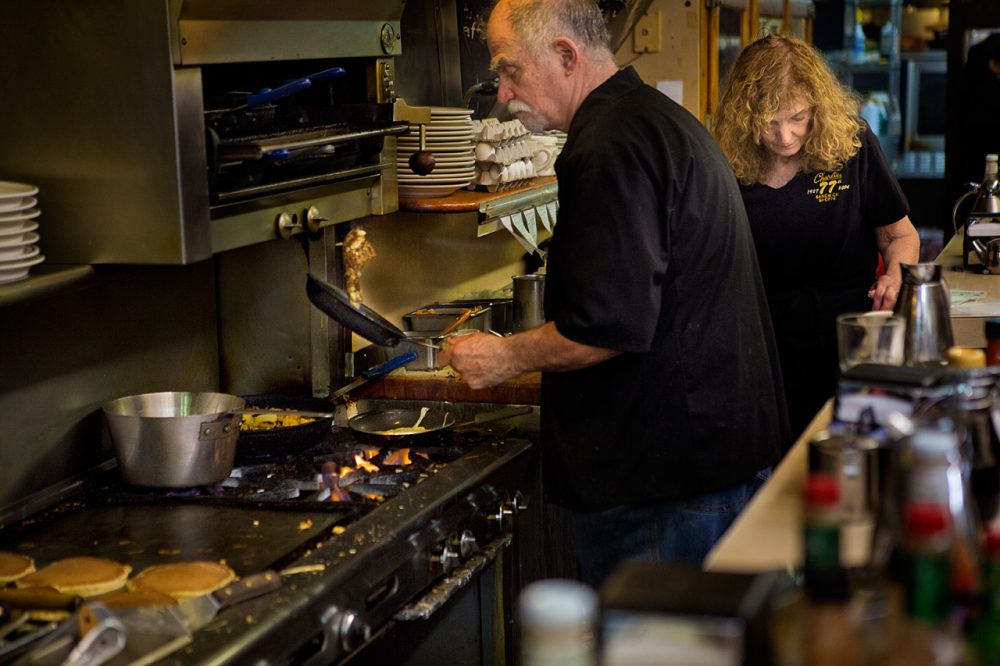 Arthur Manjourides flipping an order of Charlie’s famous turkey hash on the stovetop. (Jesse Costa/WBUR)