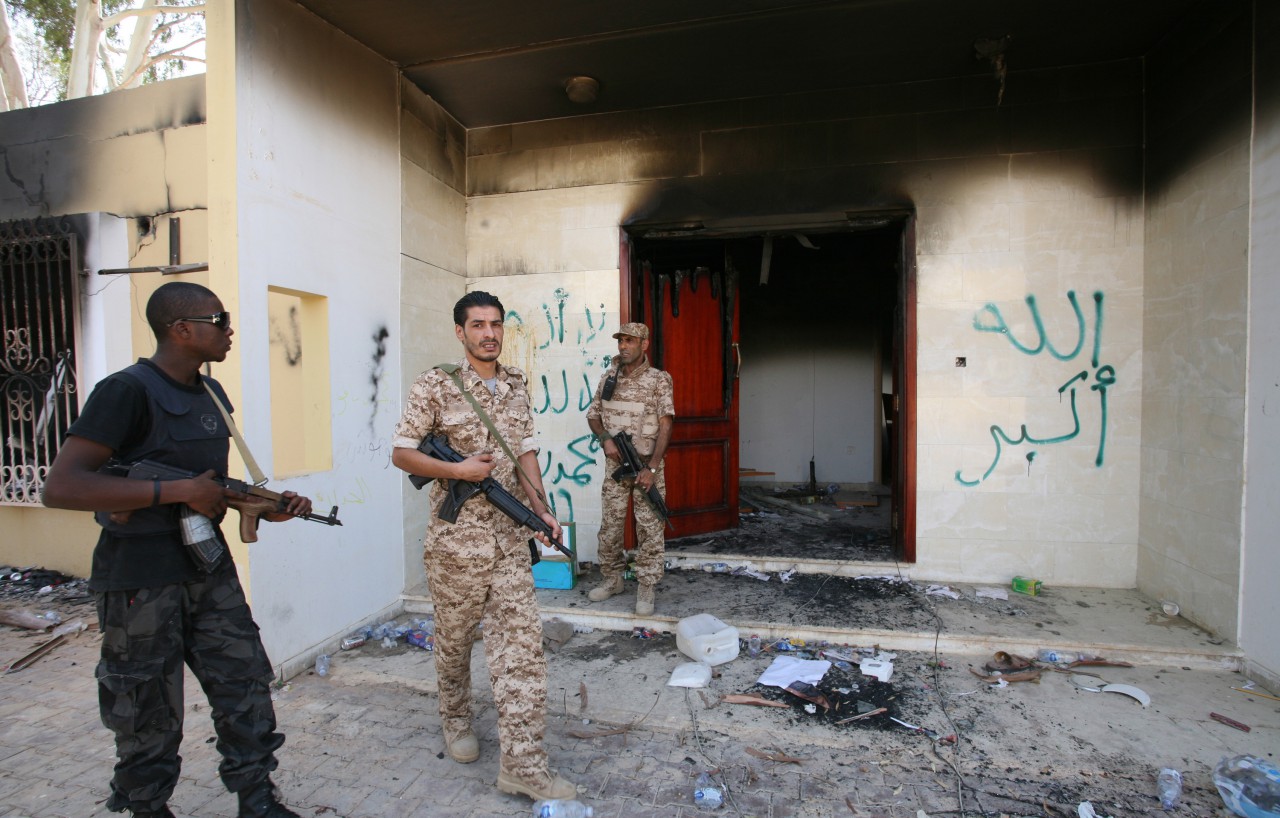 In this Friday, Sept. 14, 2012 photo, Libyan military guards check one of the U.S. Consulate's burnt out buildings during a visit by Libyan President Mohammed el-Megarif, not shown, to the U.S. consulate in Benghazi, Libya to express sympathy for the death of the American ambassador, Chris Stevens and his colleagues in the deadly Sept. 11, 2012 attack on the consulate. (Mohammad Hannon/AP File)