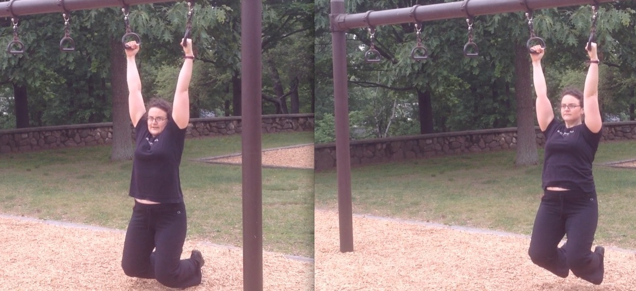 Kat demonstrates the reverse shrugs on the rings.