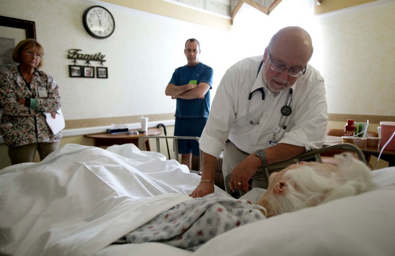 In this 2009 file photo, Dr. Joel Policzer checks on Lillian Landry in the hospice wing of an Oakland Park, Fla. hospital. Unlike most of Policzer’s patients she made end-of-life decisions. (AP File)