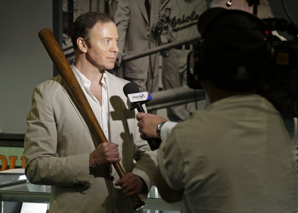 Goldin Auctions president Ken Goldin holds a baseball bat that Babe Ruth used early in his career, Wednesday, July 9, 2014, in Baltimore, as he is interviewed during a media preview of sports memorabilia slated for auction to mark the 100th anniversary of Ruth's major league debut. The auction is scheduled to take place July 12, the day after the anniversary, and the organizers estimate that 125 items to be auctioned off could fetch as much as $10 million. (Patrick Semansky/AP)