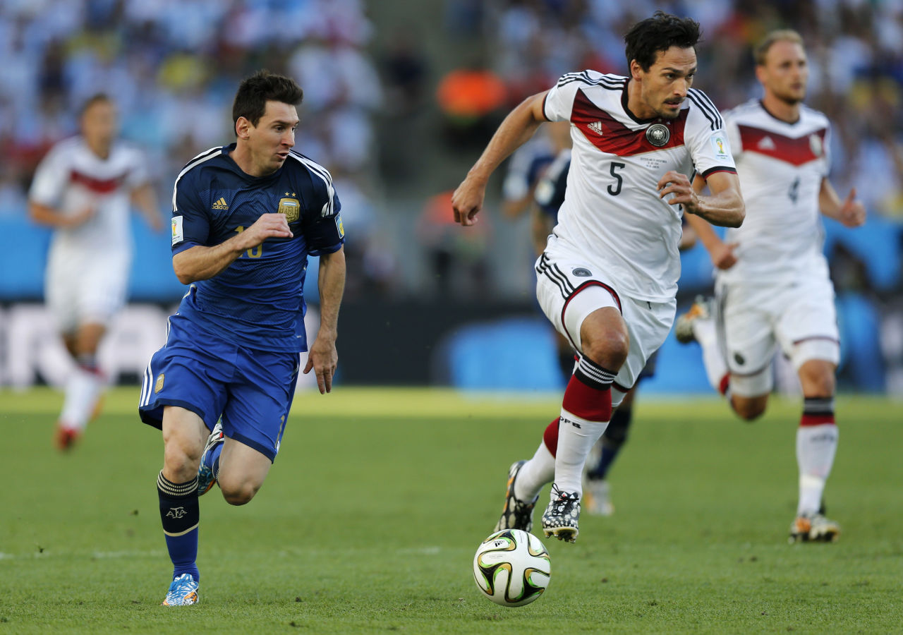 Argentina's Lionel Messi, left, and Germany's Mats Hummels go downfield during the World Cup final soccer match between Germany and Argentina at the Maracana Stadium in Rio de Janeiro, Brazil, Sunday, July 13, 2014. (Frank Augstein/AP)