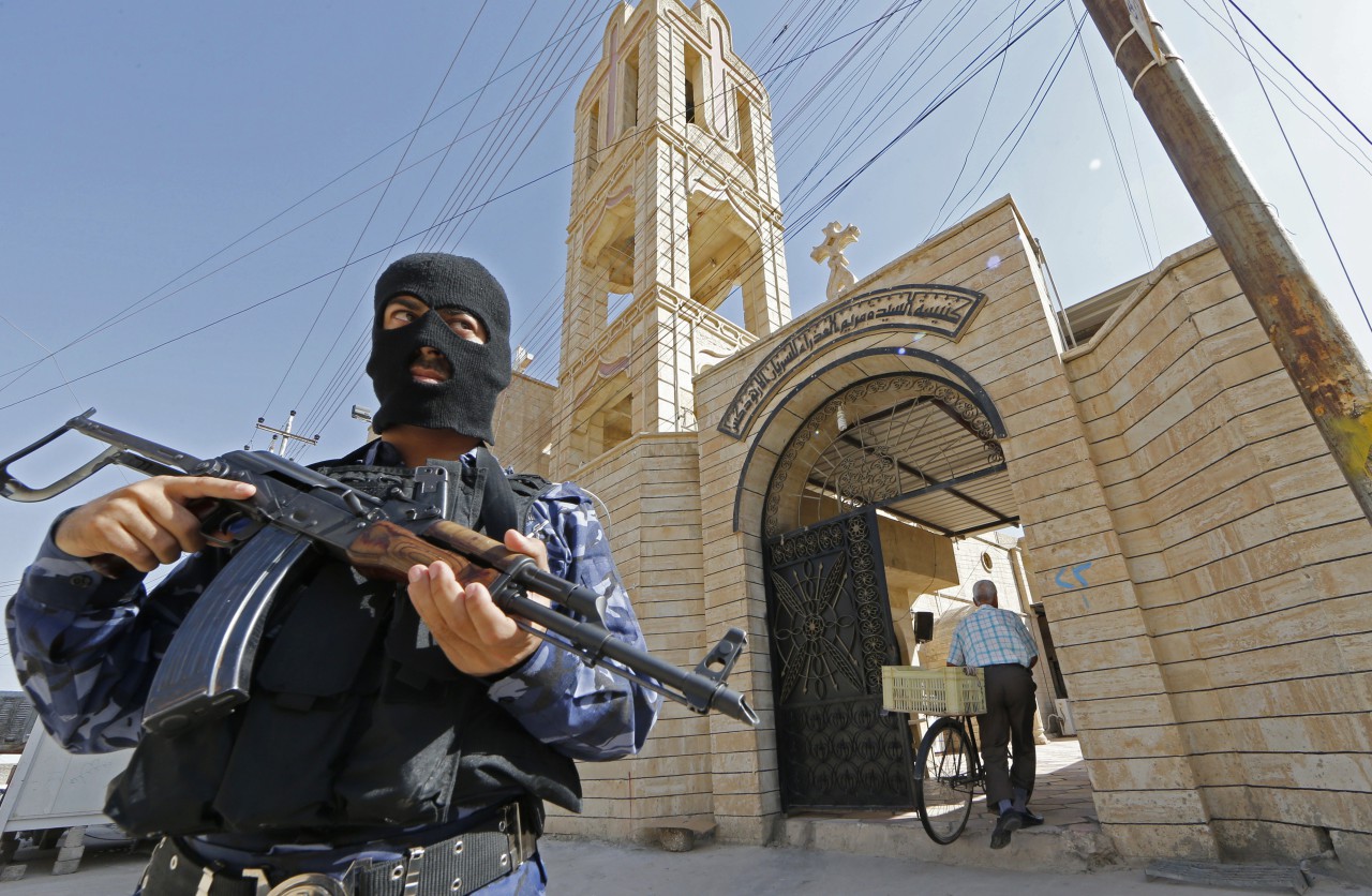 An Iraqi security officer, stands guard outside the Church of the Virgin Mary in the northern town of Bartala, on June 15, 2012, east of the northern city of Mosul. (Karim Sahib/AFP/Getty Images)