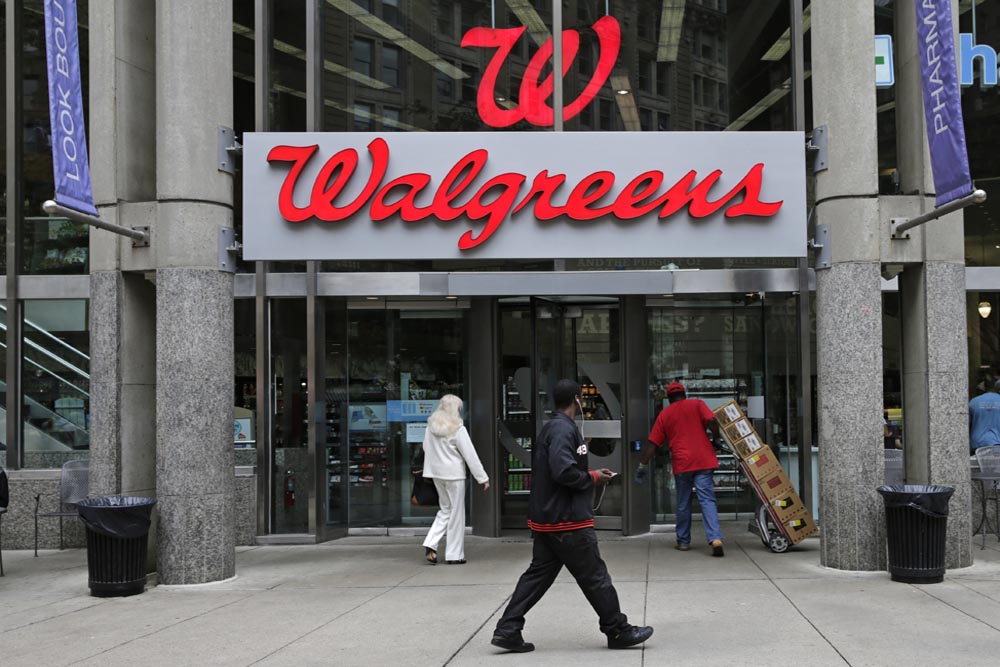 This June 4, 2014 photo shows a Walgreens retail store in Boston. Walgreen Co. _ which bills itself as “America’s premier pharmacy” _ is among many companies considering combining operations with foreign businesses to trim their tax bills. (AP)
