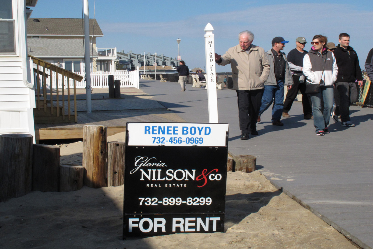 This March 8, 2014 file photo shows strollers on the boardwalk in Point Pleasant Beach N.J. walking past a home being offered as a summer rental.  (AP)