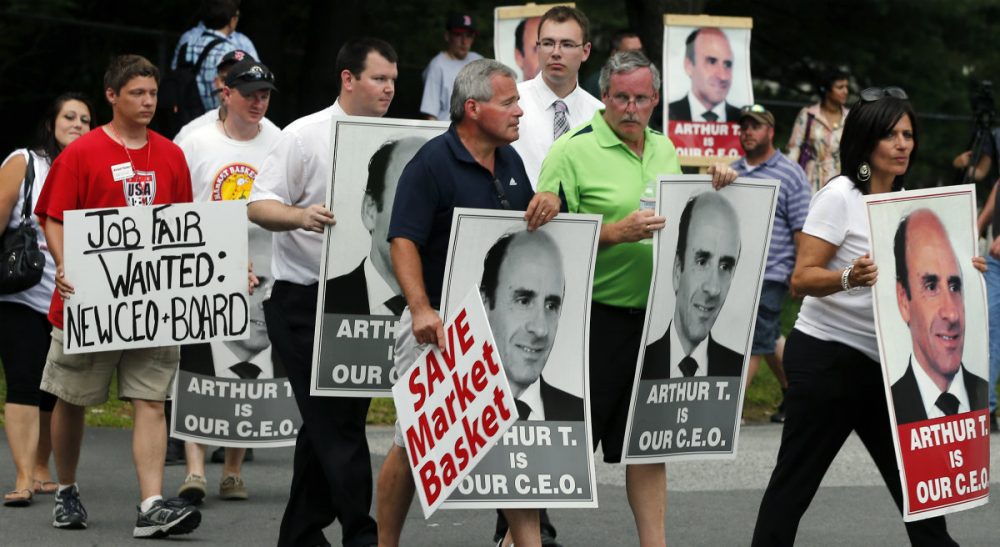 The MIT Sloan School of Management professor says the stakes are too high, and there is too much for all involved to lose, to let the conflict escalate further. Pictured: Protesters holding &quot;Arthur T&quot; signs taunt an occupant of a car driving from a Market Basket Supermarket job fair in Andover, Mass., Monday, Aug. 4, 2014. (Elise Amendola/AP)