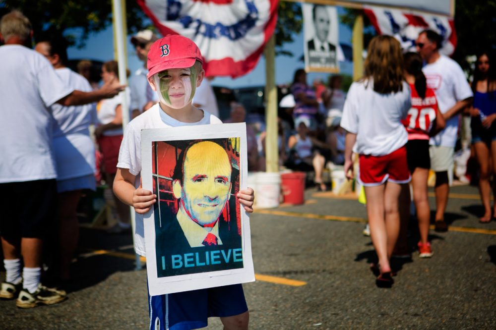 Protesters carried signs with blown-up photographs of Arthur T. Demoulas in 2016, while some loyal shoppers carried signs saying, “We are the customers. We quit.” (Jesse Costa/WBUR)