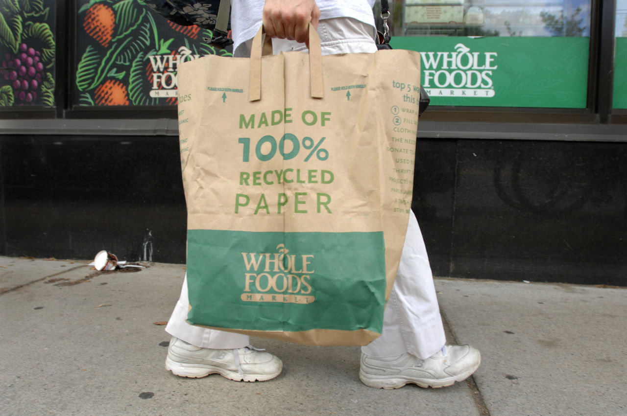 A customer walks home from the Whole Foods Market in Cambridge, Mass. in 2008 around the time of another beef recall due to E. coli bacteria. (Josh Reynolds/AP)