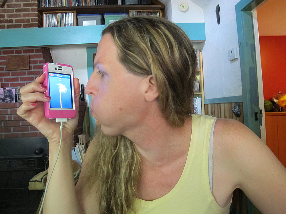 Lorelei Erisis tries out the Eva app in her Ayer home. (Martha Bebinger/WBUR)