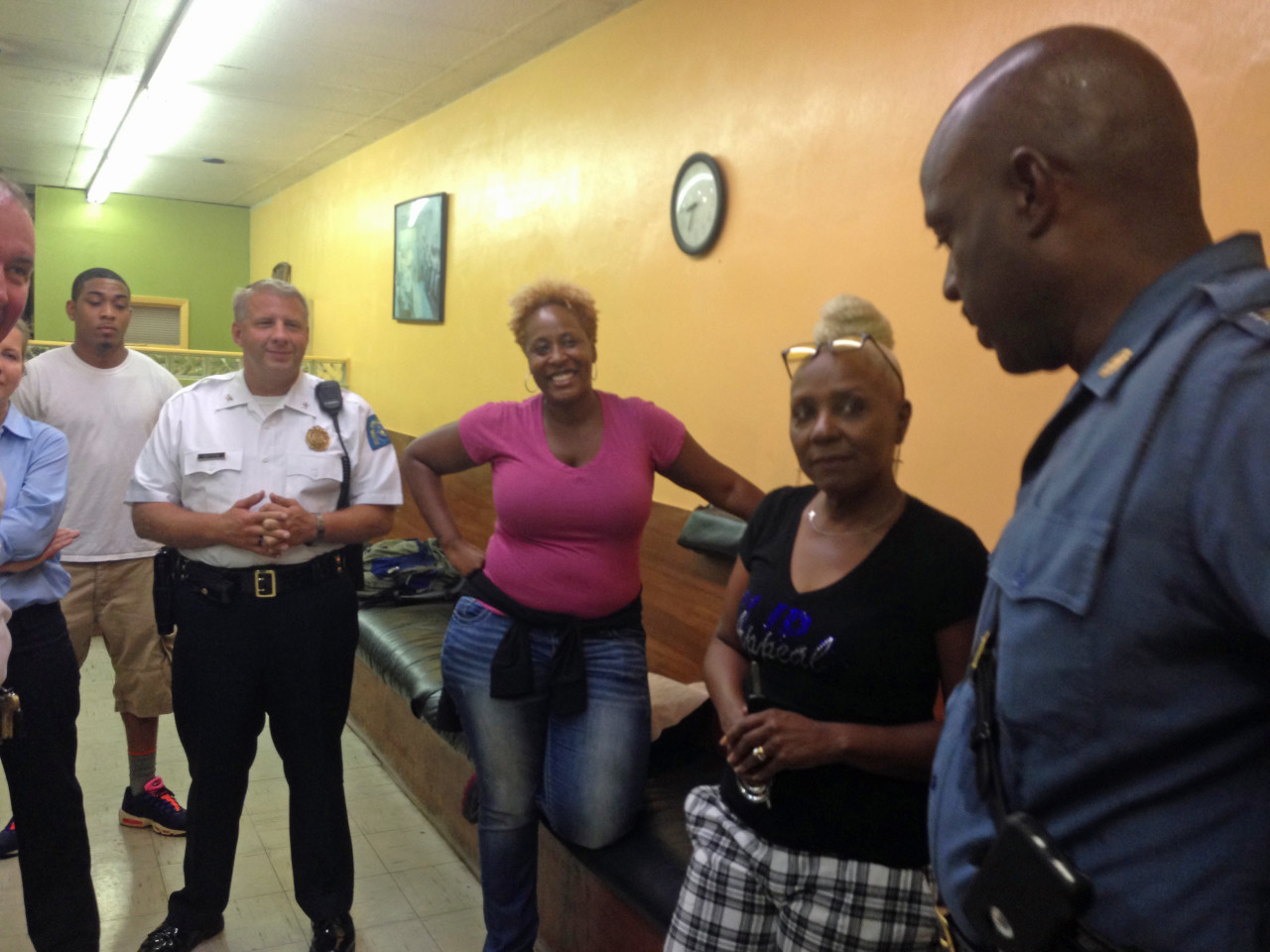 Missouri Highway Patrol Captain Ronald Johnson (right) speaks with community members including the owner of Clip Appeal barbershop, Kaye Mershon (second from right). (Deborah Becker)
