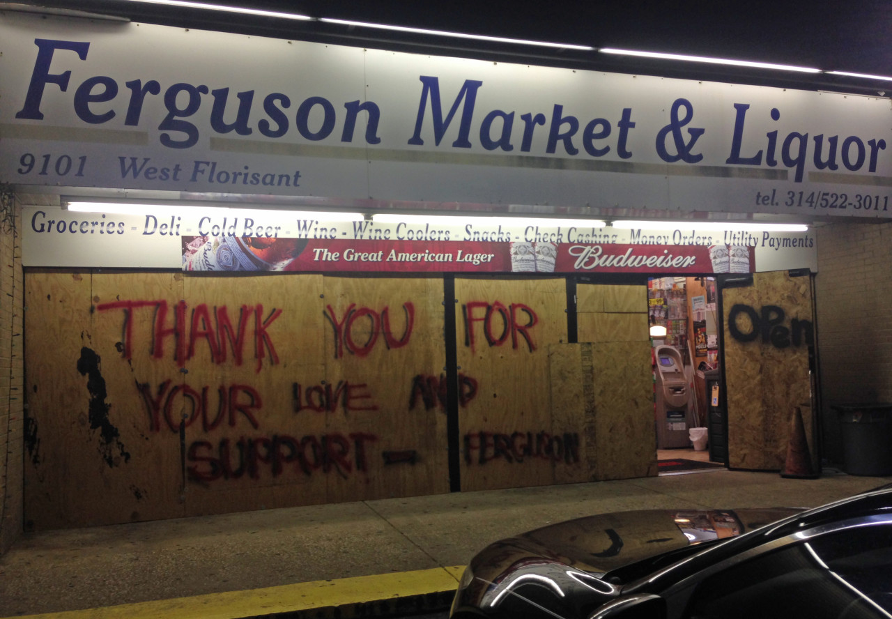Some storefronts in Ferguson are boarded up to protect the glass, but they&#039;re still open for business. (Deborah Becker)