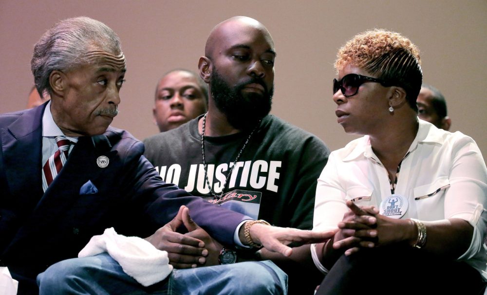 Rev. Al Sharpton, left, speaks with parents of Michael Brown, Michael Brown Sr. and Lesley McSpadden, right, during a rally at Greater Grace Church, Sunday, Aug. 17, 2014, for their son who was killed by police last Saturday in Ferguson, Mo. Sharpton told the rally Brown’s death was a &quot;defining moment for this country.&quot; (AP)