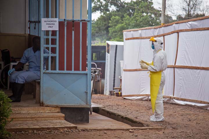 In this photo taken on Tuesday, Aug 12, 2014, a healthcare worker, right, wears protective gear against the Ebola virus before he enters the Ebola isolation ward at Kenema Government Hospital, in Kenema, the Eastern Province around 300km, (186 miles), from the capital city of Freetown in Sierra Leone. (AP)