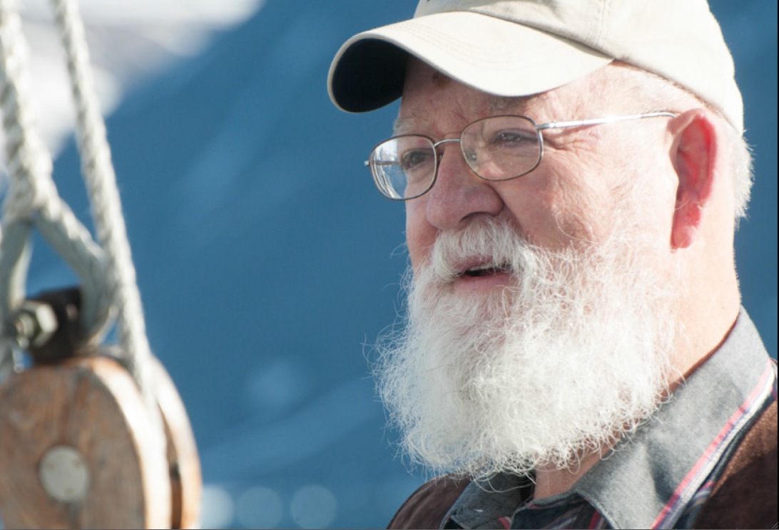 Tufts philosophy professor Daniel C. Dennett on a schooner in Greenland in June. (Courtesy of Phil Wickens)
