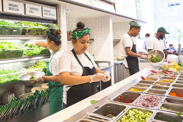 Employees at a branch of the salad green fast-casual restaurant SweetGreen prepare ingredients. (SweetGreen Restaurants) 