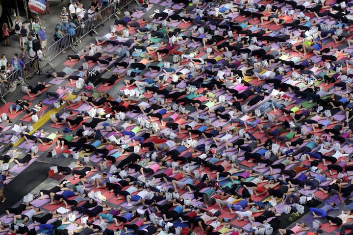 Thousands of New Yorkers marked the first day of summer by practicing yoga in Times Square, during the 12th annual Solstice in Times Square. (AP)