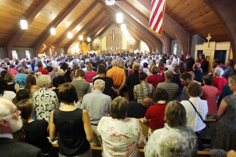 Mourners pack Our Lady of the Holy Rosary Catholic church during a special Mass for slain journalist James Foley in his hometown of Rochester, N.H., on Sunday. (Jim Cole/AP)