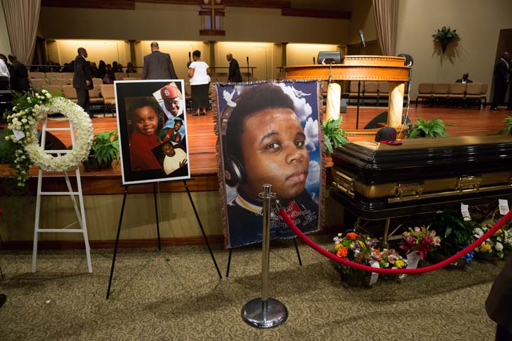 Photos surround the casket of Michael Brown before the start of his funeral at Friendly Temple Missionary Baptist Church in St. Louis, Monday, Aug. 25, 2014.  (AP)