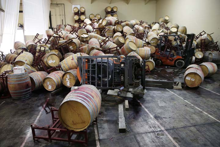 Some of the hundreds of earthquake damaged wine barrels cover and toppled a pair of forklifts at the Kieu Hoang Winery, Monday, Aug. 25, 2014, in Napa, Calif. A powerful earthquake that struck the heart of California's wine country caught many people sound asleep, sending dressers, mirrors and pictures crashing down around them and toppling wine bottles in vineyards around the region. (AP)