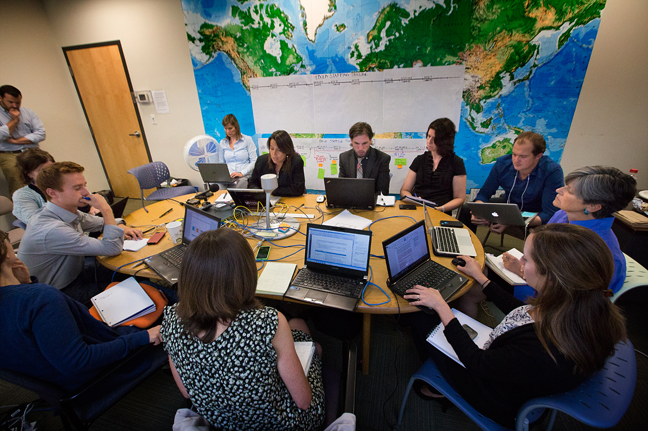 Members of Partners in Health work with representatives from Liberia and Sierra Leone via conference call to help combat the Ebola outbreak. (Jesse Costa/WBUR)