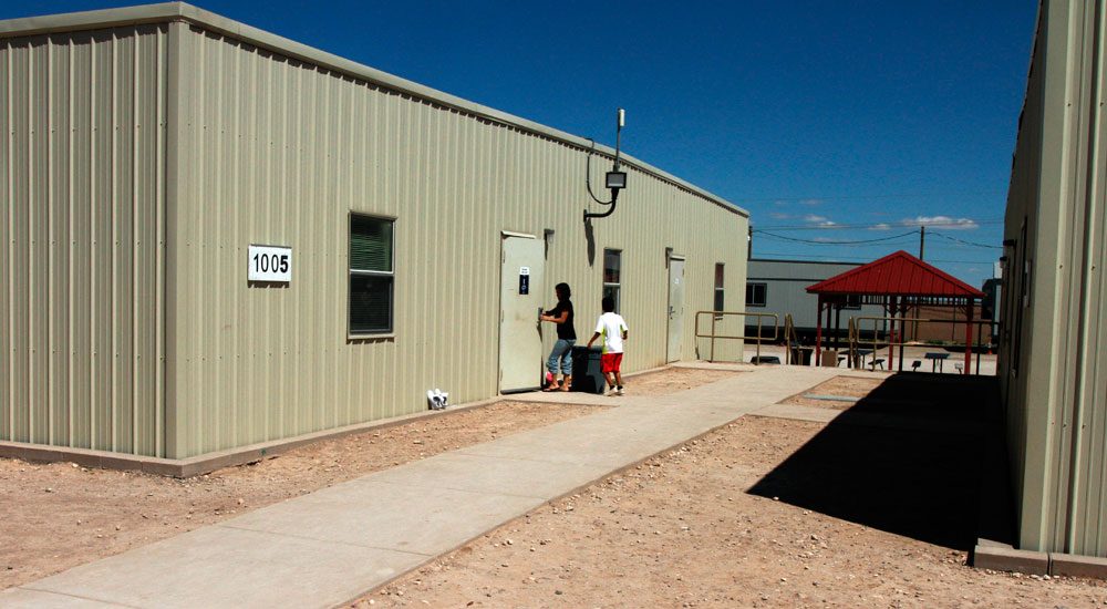 Children are seen entering a dormitory in the Artesia Family Residential Center, a federal detention facility for undocumented immigrant mothers and children in Artesia, N.M, on Sept. 10. (Juan Carlos Llorca/AP)