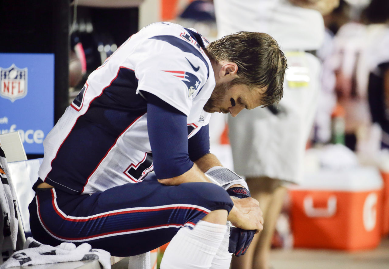 New England Patriots quarterback Tom Brady sits on the bench during the fourth quarter against the Kansas City Chiefs where they lost 41-14 Monday night in Kansas City. (Charlie Riedel/AP)