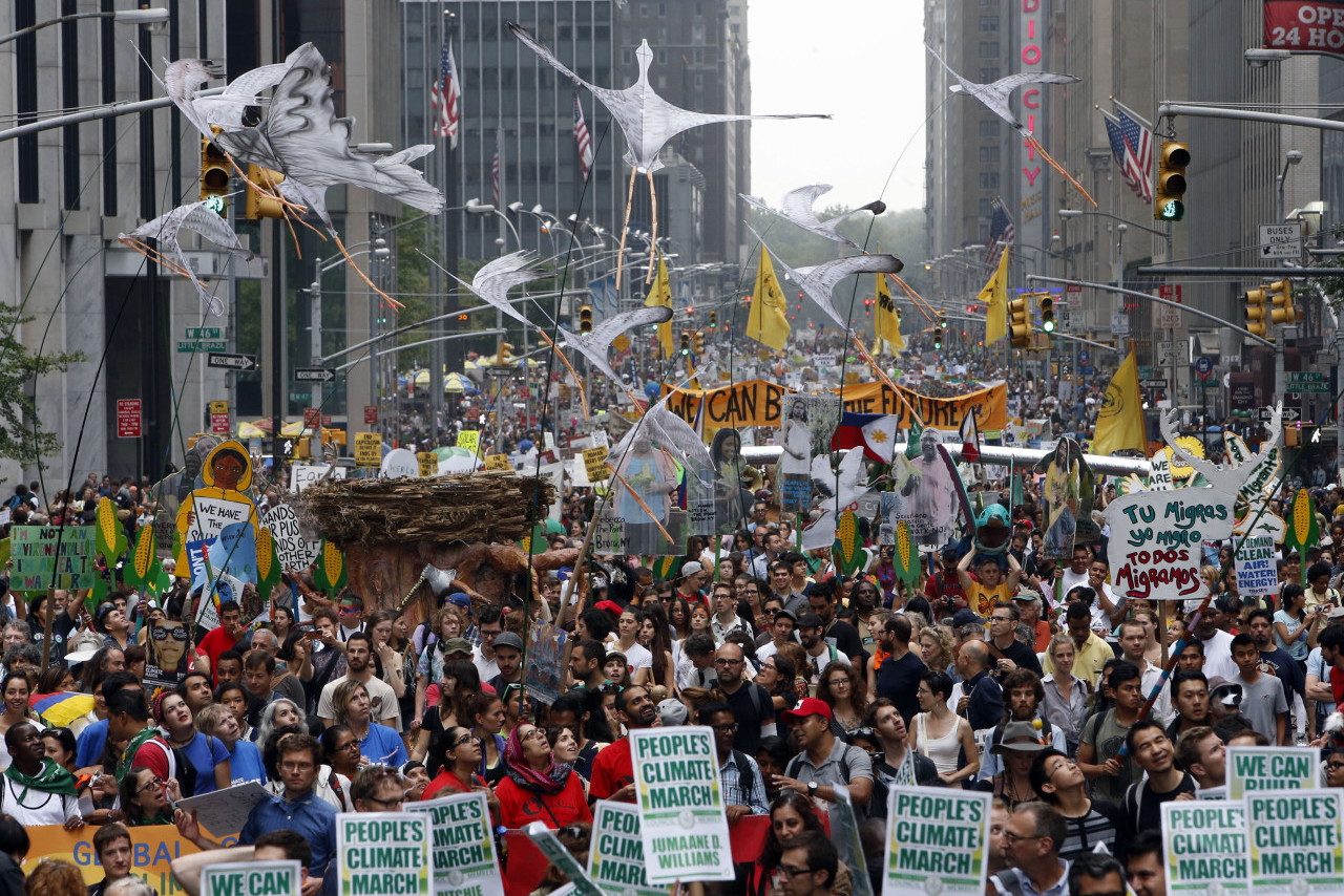 Demonstrators make their way down Sixth Avenue in New York during the People's Climate March Sunday, Sept. 21, 2014. (AP/Jason DeCrow)