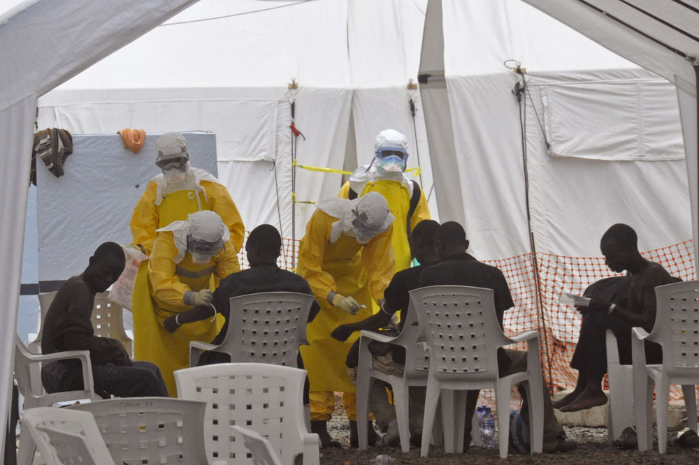Health workers,  attend to patients that contracted the Ebola virus,  at a clinic  in Monrovia, Liberia, Monday, Sept. 8, 2014. (AP/Abbas Dulleh)