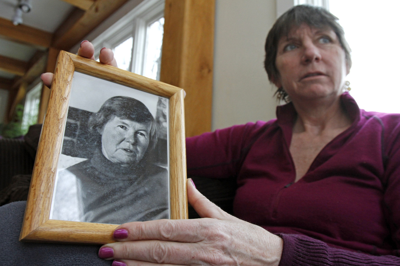 Cindy Cook holds a photo of her mother, former Rep. Alice Cook Bassett, at her home in Calais, Vt., Tuesday, March 13, 2012. Cook took care of her mother in December when she decided to stop eating and drinking to put an end to her life. (AP)