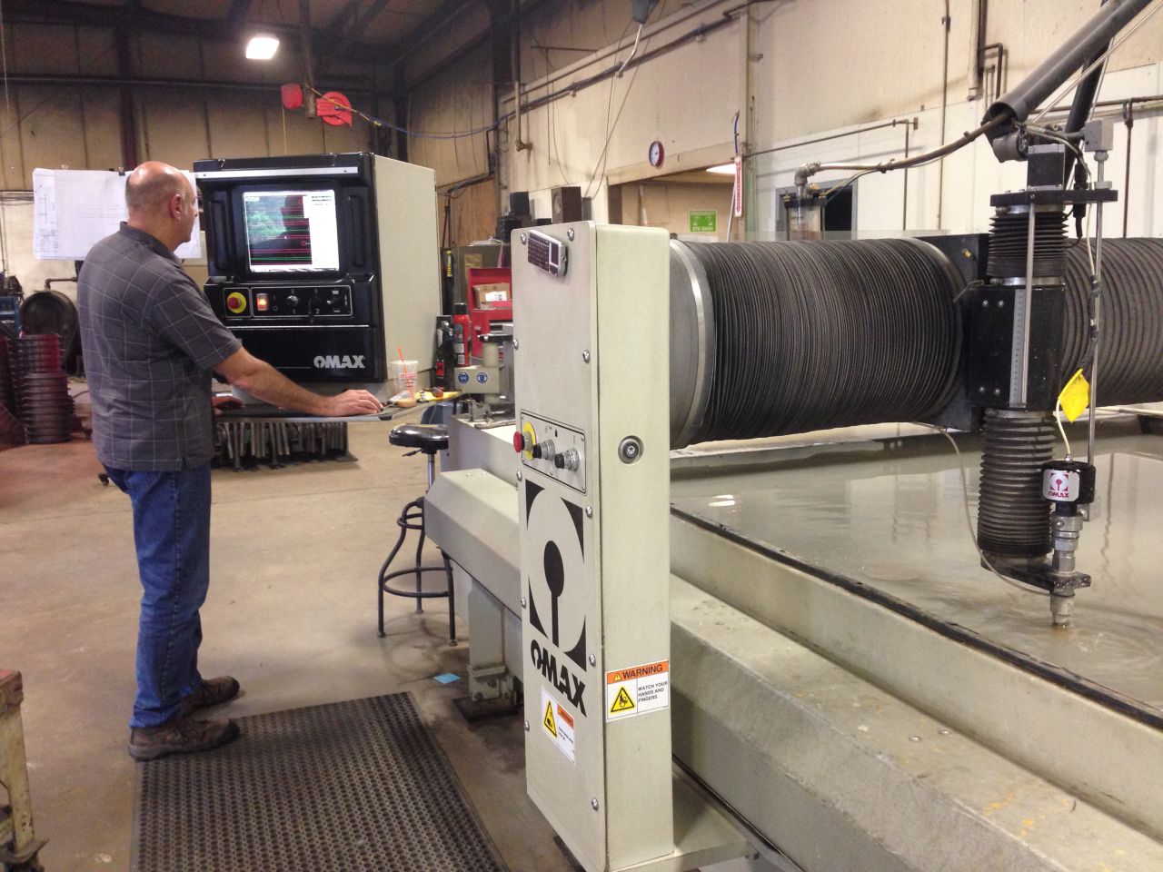 Mark Fisher in his metal fabrication company in Auburn. (Curt Nickisch/WBUR)