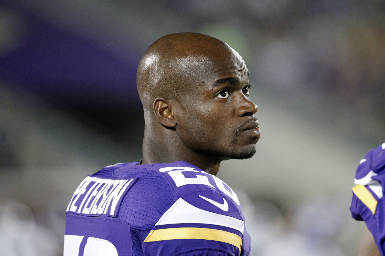 Minnesota Vikings running back Adrian Peterson watches from the sidelines against the Oakland Raiders during the second half of a preseason NFL football game at TCF Bank Stadium in Minneapolis, Friday, Aug. 8, 2014. (AP/Ann Heisenfelt)