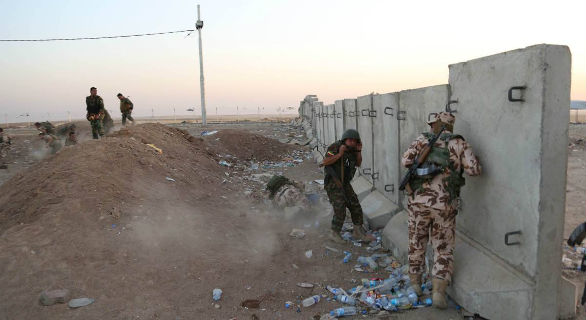 John Tirman:
"Rarely has a major military initiative by a president been greeted with such ambivalence. It’s not hard to understand why." Pictured: In this Aug. 8, 2014, file photo, Kurdish peshmerga fighters take cover during airstrikes targeting militants of the Islamic State group near the Khazer checkpoint outside of the city of Irbil in northern Iraq. (Khalid Mohammed/AP)