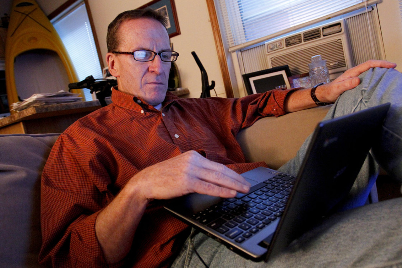 Kevin Evans relaxes in his small apartment after arriving home from work. Evans, who lost income and his home in the recession, is now having his wages garnished after falling behind on his credit card payments. (AP)